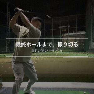 練習場でゴルフスイングをしている様子